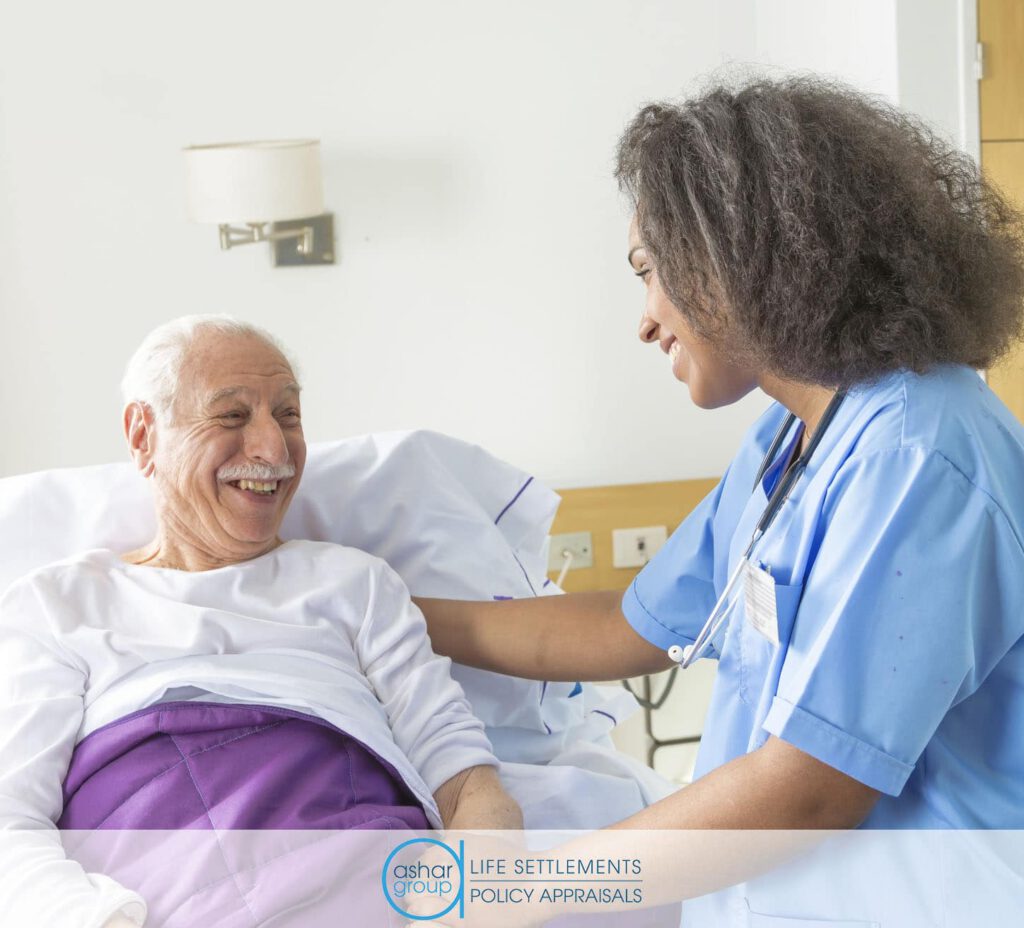 Happy senior man in bed in a long-term care facility talking to a nurse