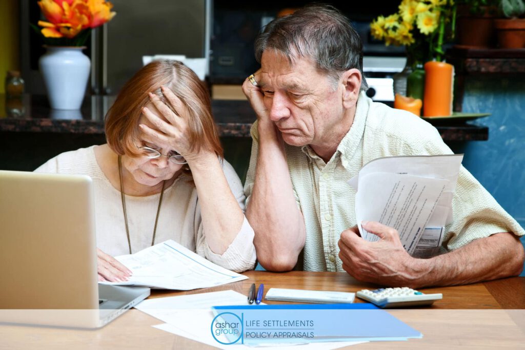 Senior couple going over bills and experiencing financial stress