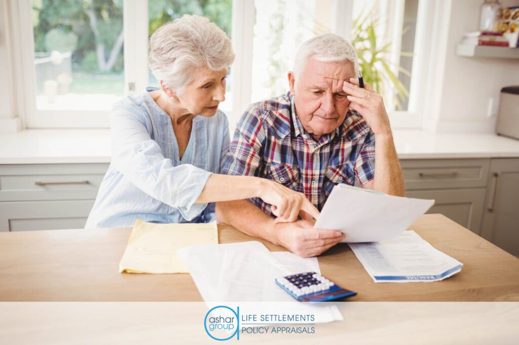 Stressed senior couple worrying about life insurance premium going up in need of life settlement