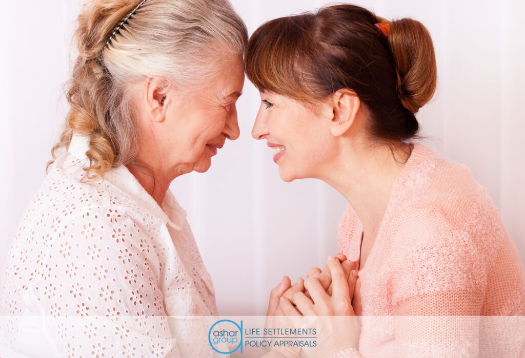 Senior woman with loving caregiver holding hands and smiling