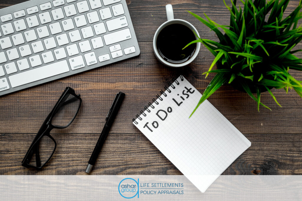 Financial advisor’s desk with to-do list and pen lying next to keyboard